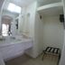 Mar de Cortez in Cabo San Lucas: compact bathroom vanity, walk-in closet, and luggage bench