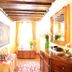 Art Palace - Residenza Giardini in Venice, bright room with wood beams, tapestry, mirror and chest.