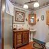 Osceola Mill House B&B in Gordonville bathroom with shower, pedestal sink, toilet and rustic wood vanity