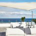Kurhotel Skodsborg in Copenhagen rooftop terrace with white seating, shade sail, and ocean view