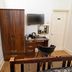 G Boutique Hotel Portsmouth room with wardrobe, desk, wall-mounted TV and chair