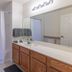 Villas at Seven Dwarfs Lane Resort Kissimmee bathroom with vanity, large mirror and shower curtain