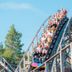 Power Park Accommodation in Kauhava with a wooden roller coaster carrying riders outdoors