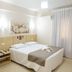 SJ Tour - San Juan Foz do Iguaçu guest room with double bed, bedside table and curtained window