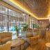 Grifid Hotel Vistamar - Ultra lobby in Golden Sands with warm wood ceiling, seating, and large windows