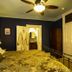 Swantown Inn & Spa Olympia guest room with iron bed, robe, ceiling fan and vanity