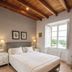 Agroturisme Sa Torre room in Santa Eugènia with wood-beam ceiling, bed, and open window view