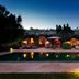 Le Jardin Des Douars in Essaouira with a lit poolside terrace and lounge chairs at dusk