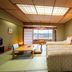 Hotel Kazuno in Kazuno guest room with twin beds, tatami floor and a view through sliding doors