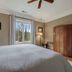 Chateau de Vie in Calistoga bedroom with king bed, window view, lamps and wooden armoire