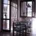 Hotel La Rosta in Reggio nell'Emilia dining area with glass table, chairs, and open windows