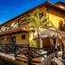 Rio Búzios Beach Hotel in Búzios with balconies, palm trees and a sunny terrace exterior