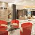 Ayara Grand Palace Hotel in Phitsanulok lobby with red chairs and reception desk