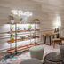 Fraser Suites Singapore lobby lounge with neon sign, plant shelf, seating area and floor lamp