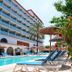 Ibersol Playa Dorada in El Vendrell with outdoor pool, lounge chairs, and palm-lined garden