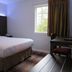 Luxbury Inn & Suites in Maryville guest room with bed, desk, chair, and window