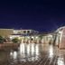 I Giardini di Cala Ginepro Hotel Resort in Cala Liberotto, lit courtyard with wet tiled paving at night