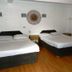 Azzurro Di Boracay Resort in Boracay room with two beds, wood flooring, and white brick wall