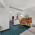 Comfort Inn & Suites Berea guest room with desk, chair, sofa and TV