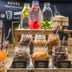 Breakfast buffet at ibis Barcelona Santa Coloma with jars of toppings and fresh fruit-infused water