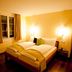Hotel Goldener Schlüssel in Altdorf bedroom with warm lighting, window and double bed