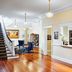 Inn at Carnall Hall in Fayetteville: bright lobby with hardwood floors, staircase, and blue seating