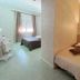 Hotel De La Plage in Valras-Plage shows a simple twin guest room with two single beds and a window