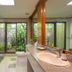 Comsaed River Kwai Resort in Kanchanaburi bathroom with tub, glass shower, and garden-view window