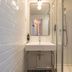 ibis Styles Paris Eiffel Cambronne bathroom with sink, mirror and glass shower in Paris
