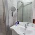 Jaegerstube in Görgeshausen bathroom with shower, sink, mirror, and tiled walls