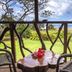 Keuhenua Hostal in Hanga Roa balcony with table, chairs, garden and ocean view