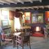 The Bay Horse Hotel And Restaurant in Ulverston lounge with fireplace, wooden chairs and exposed beams