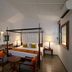 Habarana Village by Cinnamon in Habarana features a canopy bed, seating area, and open doorway to greenery.