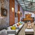 Charm Hotel Budapest lounge with glass سقف, long bar, and colorful sofas in Budapest