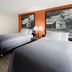 Super 8 by Wyndham Bulls Gap Greeneville Area room with two beds and orange accent wall