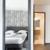 Lille City Hotel in Lille guest room with bed, open bathroom door, and kitchenette