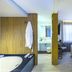 Hotel Melo in Balneário Camboriú: guest room with bathtub, vanity, and bed by a bright window