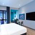 Ibis Styles Sepang Klia guest room with bed, desk, wall TV and balcony view in Sepang