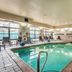 Indoor pool at Fairfield Inn & Suites by Marriott Alamogordo with lounge chairs and large windows