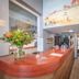 Two Brothers Hotel Astoria Noordwijk reception desk with flower arrangement and hallway