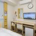 Toyoko Inn Gifu-hashima-eki Shinkansen Minami-guchi room with bed, desk, TV and wall clock in Ichinomiya