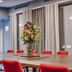 Go Hotel Østerport meeting room in Copenhagen with long table, red chairs and floral centerpiece