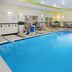 Indoor pool at Fairfield Inn & Suites by Marriott Cookeville with lounge chairs and bright lighting