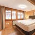 Gasthof Bären in Habkern guest room with double bed, wood-paneled walls and window view