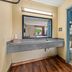 Econo Lodge Charlotte Airport Area bathroom with granite sink vanity and tiled toilet shower area