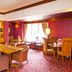 Premier Inn Huddersfield Central dining area with wooden tables, brown chairs and large window