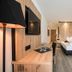 Hotel Bad Fallenbach room with double bed, desk and wall-mounted TV in San Leonardo in Passiria