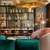 Motel One München-Westend lounge with velvet chairs, tables, and open shelving in Munich