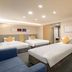 Hotel Jal City Kannai Yokohama in Yokohama guest room with three beds, sofa, and TV