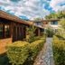 Hotel Serra Everest in Nova Friburgo with stone garden path, hedges, and fountain courtyard